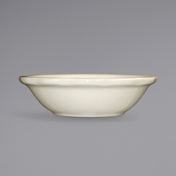 An International Tableware Victoria ivory stoneware bowl with a scalloped edge on a white background.