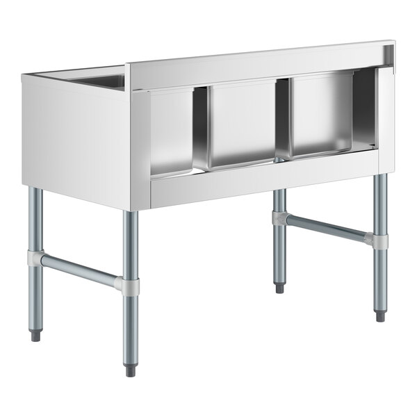 A stainless steel three-compartment sink with four metal legs and an open front design.