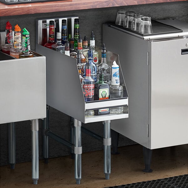 A Regency stainless steel five-tiered liquor display shelf holding bottles on a counter in a cocktail bar.