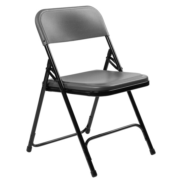 A black National Public Seating metal folding chair with a charcoal slate seat.