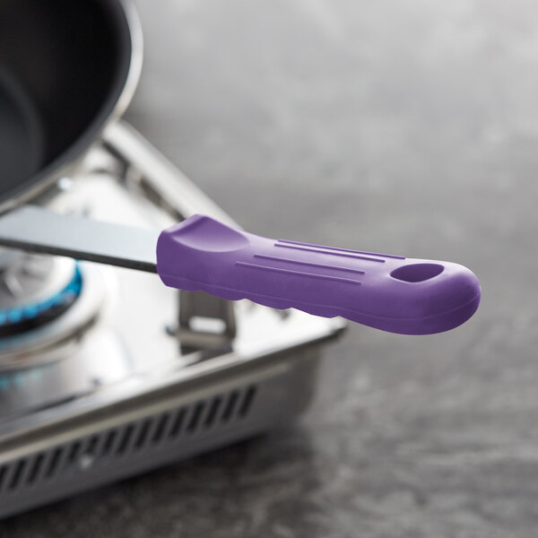 A purple silicone handle sleeve on a frying pan.