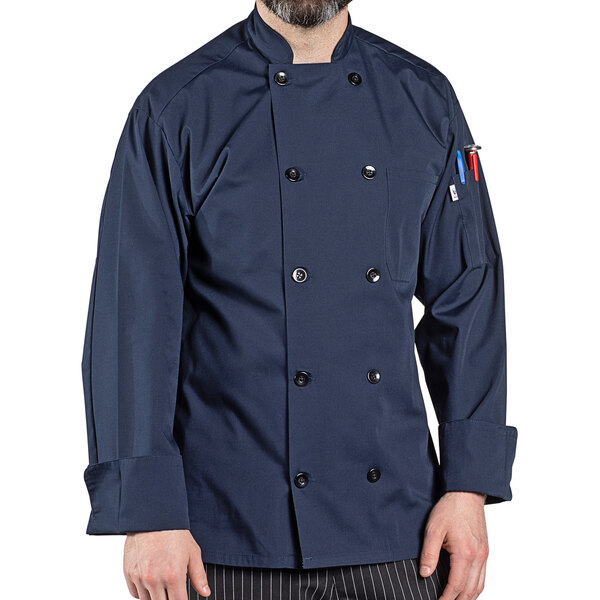 A man wearing a navy blue Uncommon Chef long sleeve chef coat.