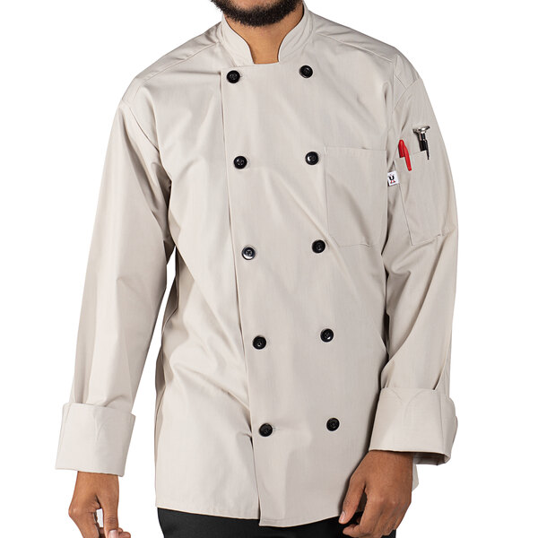 A man wearing a white Uncommon Chef long sleeve chef coat with 10 buttons and a stone finish.