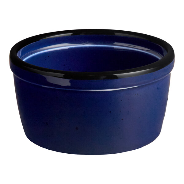 A blue stoneware ramekin with a black rim.