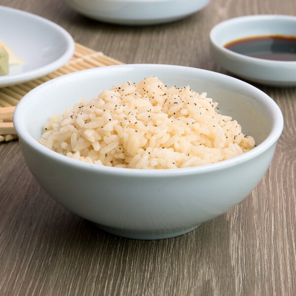 A white Thunder Group melamine bowl filled with rice on a table.