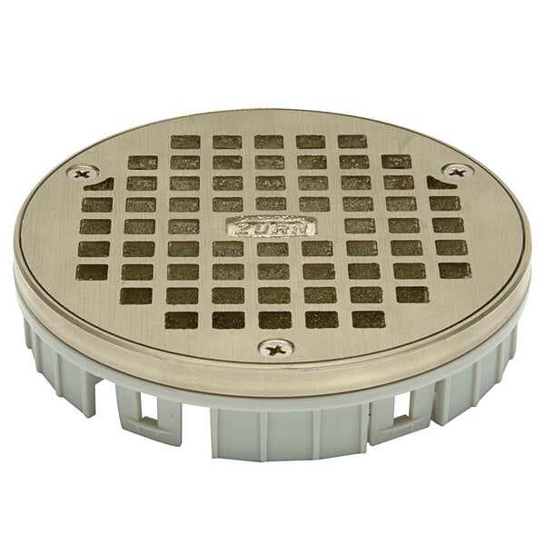 A Zurn round metal drain cover with holes.