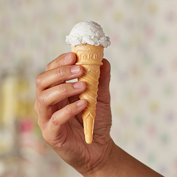 A hand holding a Keebler Eat-It-All Junior Torch Cake Cone filled with ice cream.
