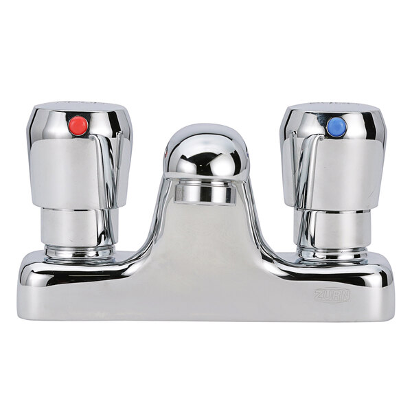 A Zurn deck mount metering faucet with a silver spout and red and blue buttons.