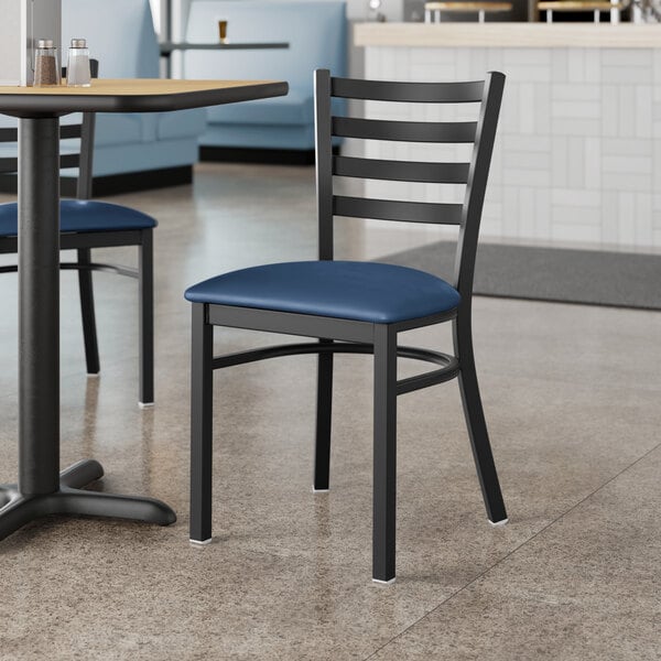 Lancaster Table & Seating Black Finish Ladder Back Chair with 2 1/2" Navy Vinyl Padded Seat - Detached