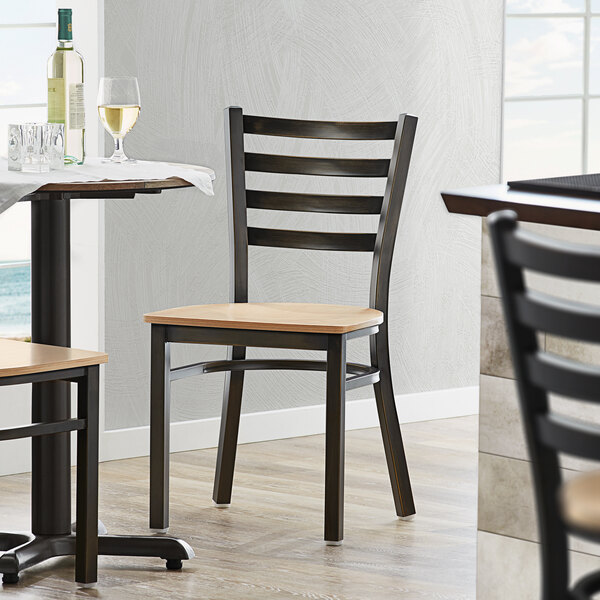 A Lancaster Table & Seating distressed copper finish ladder back chair with a natural wood seat at a table in a restaurant.