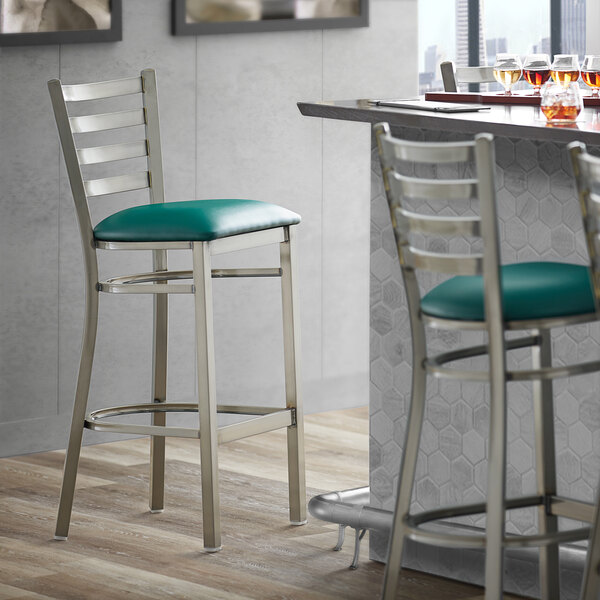 Lancaster Table & Seating Clear Coat Finish Ladder Back Bar Stool with 2 1/2" Green Vinyl Padded Seat