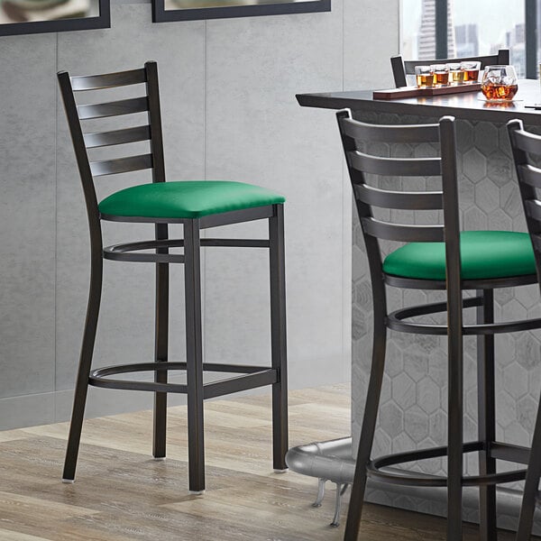 Lancaster Table & Seating Distressed Copper Finish Ladder Back Bar Stool with 2 1/2" Green Vinyl Padded Seat - Assembled