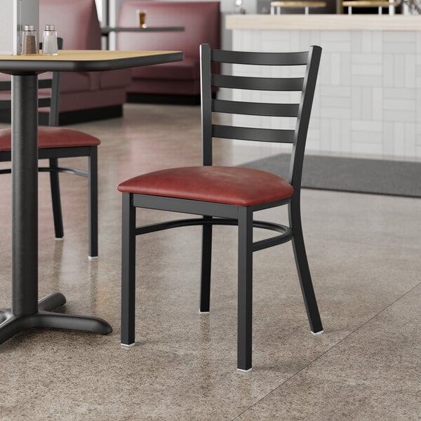 Lancaster Table & Seating Black Finish Ladder Back Chair with 2 1/2" Burgundy Vinyl Padded Seat