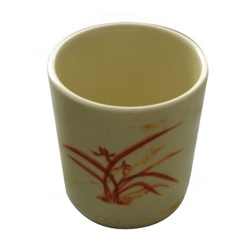 A white melamine mug with a gold orchid design on it.
