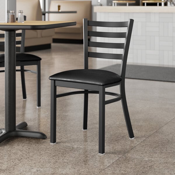 Lancaster Table & Seating Black Finish Ladder Back Chair with 2 1/2" Black Vinyl Padded Seat - Assembled