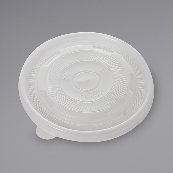 A white plastic lid with a circular design and a number.