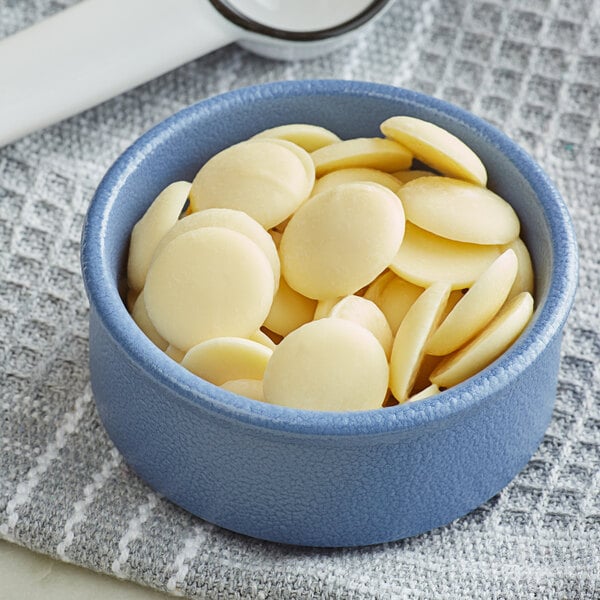 A blue bowl of Guittard white chocolate wafers.