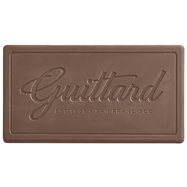 A brown rectangular Guittard milk chocolate bar with writing on it.