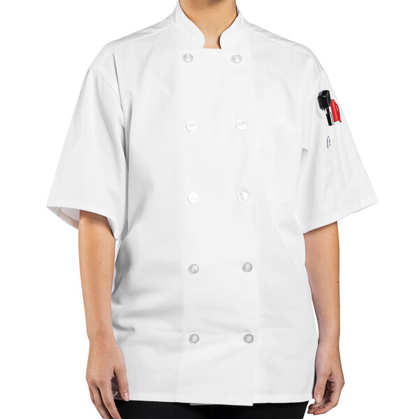 A woman wearing a white Uncommon Chef short sleeve chef coat.