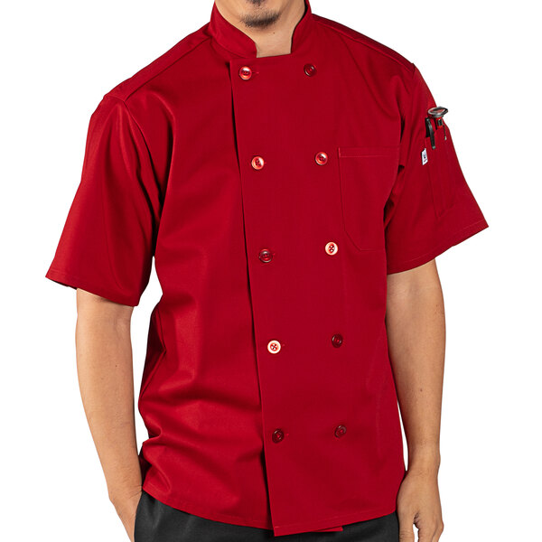 A man wearing a Uncommon Chef red short sleeve chef coat.