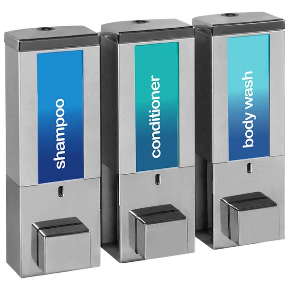 A chrome wall-mounted shower dispenser with three satin silver bottles. Each bottle has a blue or green label.