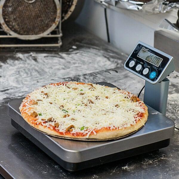 A pizza on a San Jamar digital kitchen scale.