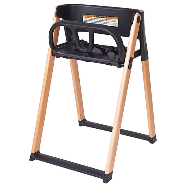 A Koala Stowe high chair with a black seat and wood frame.