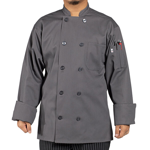 A man wearing an Uncommon Chef Orleans slate gray long sleeve chef coat.