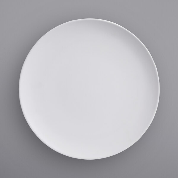 An American Metalcraft matte white melamine plate with a white rim on a gray surface.