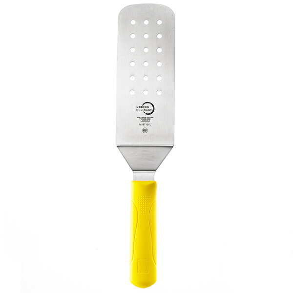 A Mercer Culinary Millennia Perforated Turner with a yellow handle.