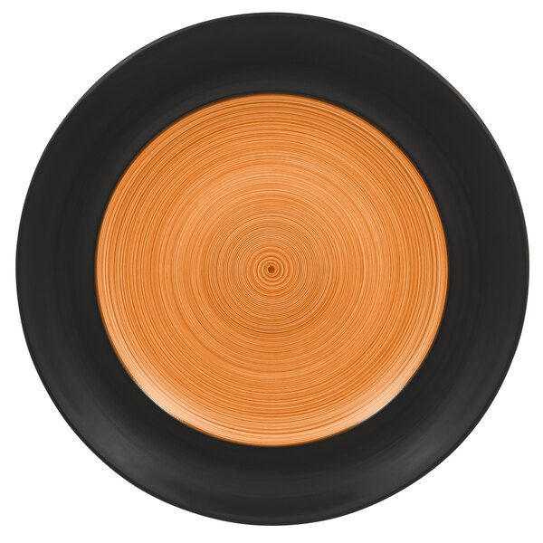 A close up of a RAK Porcelain Trinidad wide rim flat plate with a circular design in cedar and black.