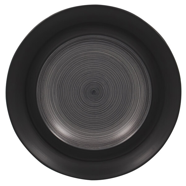 A circular black RAK Porcelain plate with a spiral pattern in the center.
