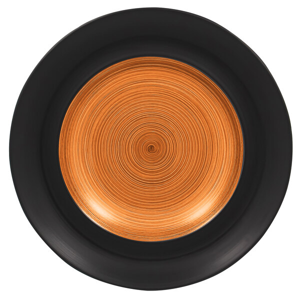 A close up of a RAK Porcelain Trinidad cedar and black porcelain plate with a spiral design in black and orange.