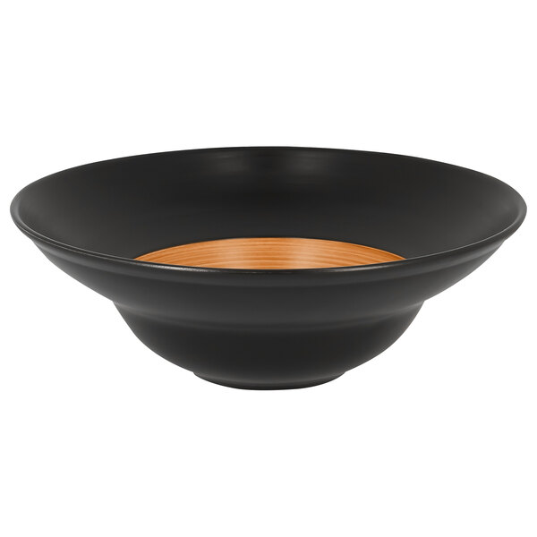 A black porcelain plate with a wood grain rim and brown center.