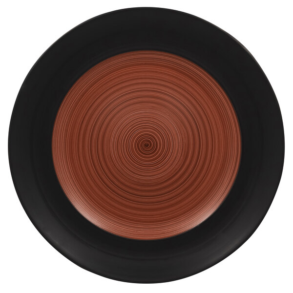 A brown and black porcelain plate with a circular pattern on the rim.