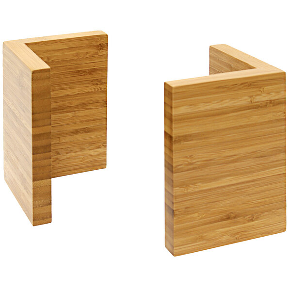 Two natural bamboo L-shape risers on a table.