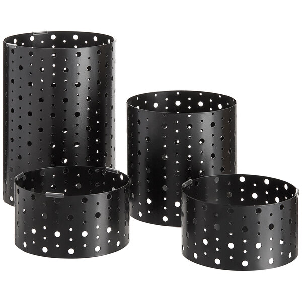 A group of black metal containers with holes on the sides.