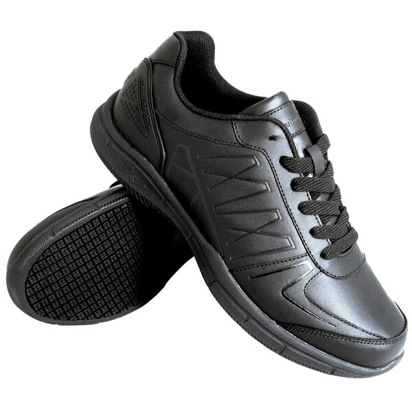 A pair of Genuine Grip black athletic shoes with laces.