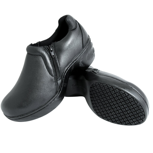 A pair of Genuine Grip black leather slip-on shoes with a zipper.
