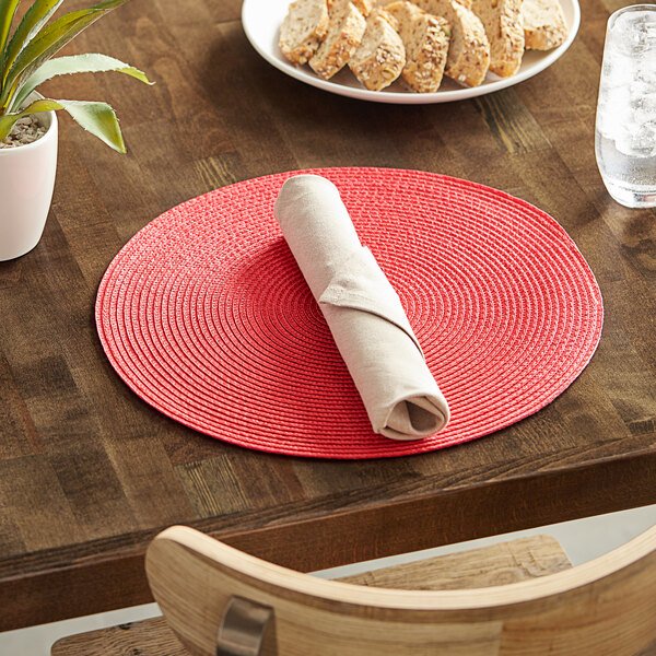 A table set with a RITZ cherry placemat and a plate of food.