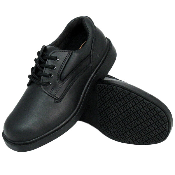 A pair of black Genuine Grip women's leather work shoes with black soles.