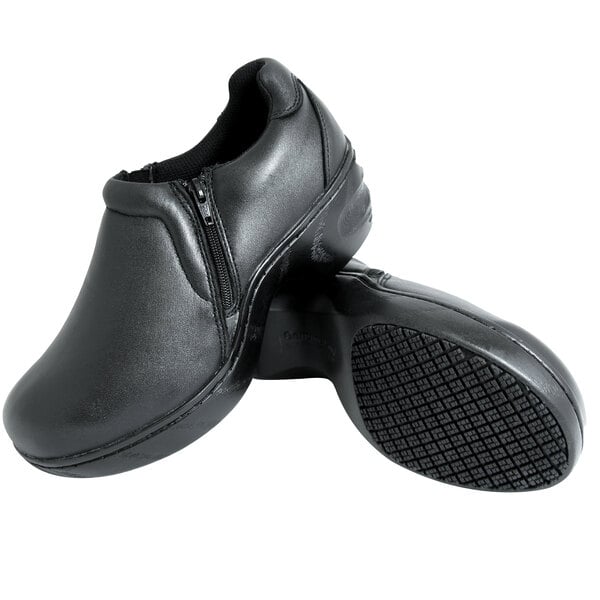 A pair of Genuine Grip black leather shoes with a side zipper.