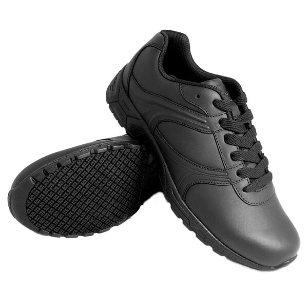 A pair of Genuine Grip black leather shoes with laces.