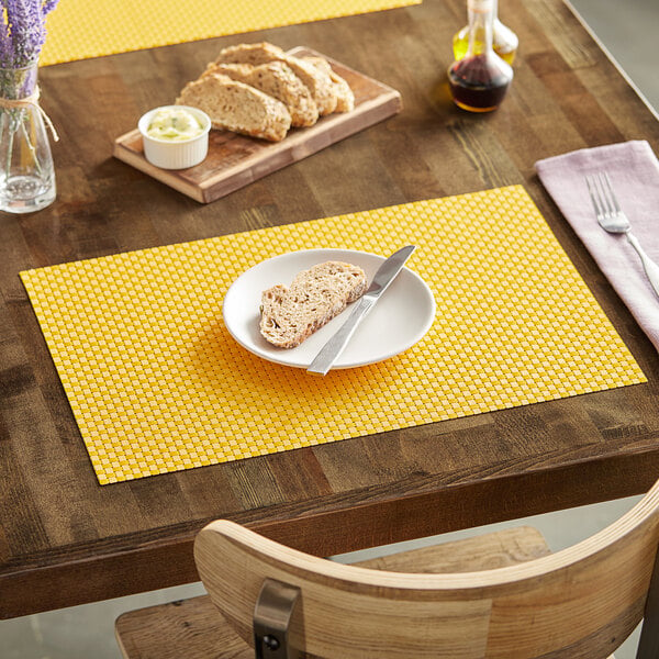 A RITZ® lemon placemat on a table with a plate of food and a knife.