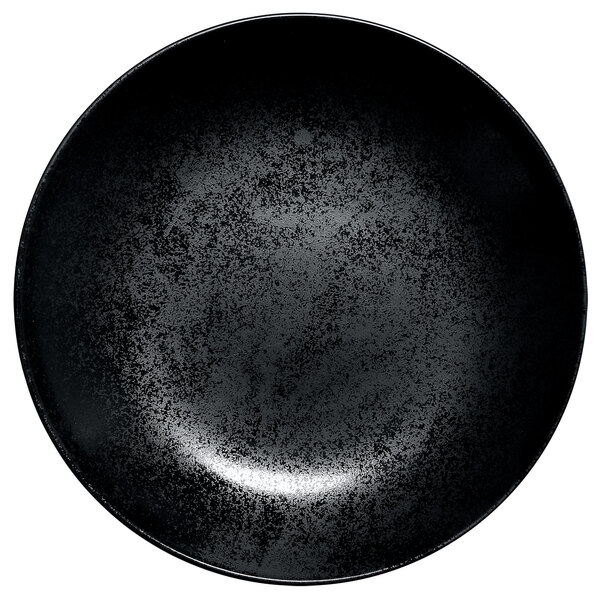 A white background with a black RAK Porcelain Karbon round deep porcelain plate with specks.
