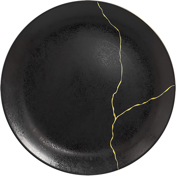 A RAK Porcelain black round flat porcelain plate with gold lines on the edge.