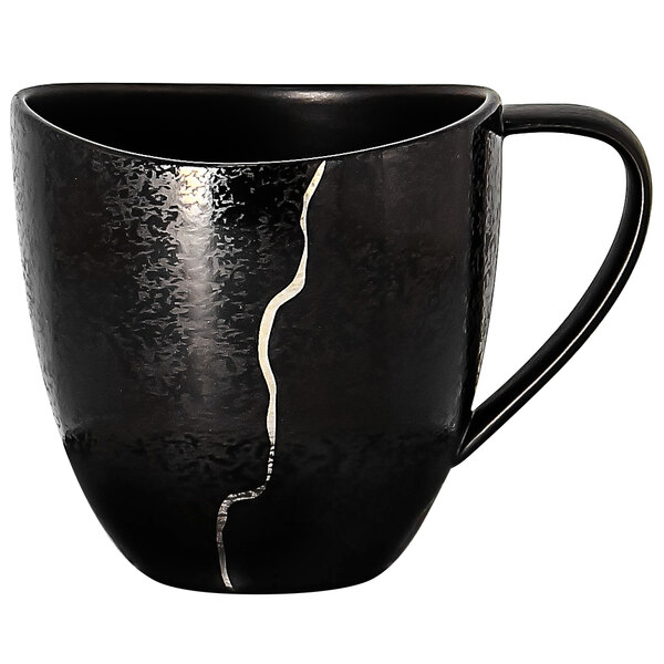 A black porcelain coffee cup with silver crack details.