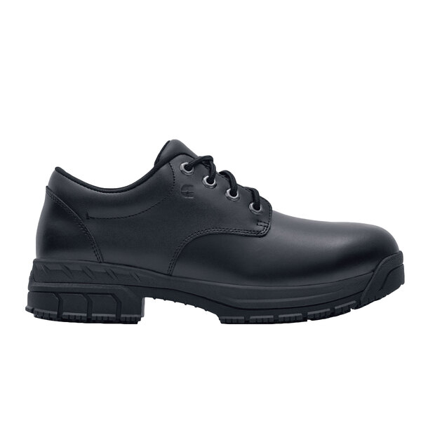 A black Shoes For Crews work boot for women with laces and a rubber sole.