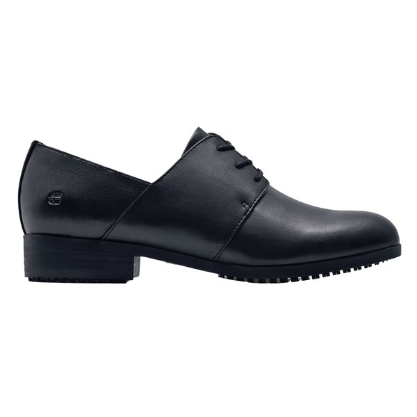 A pair of black Shoes For Crews women's dress shoes with a leather sole.