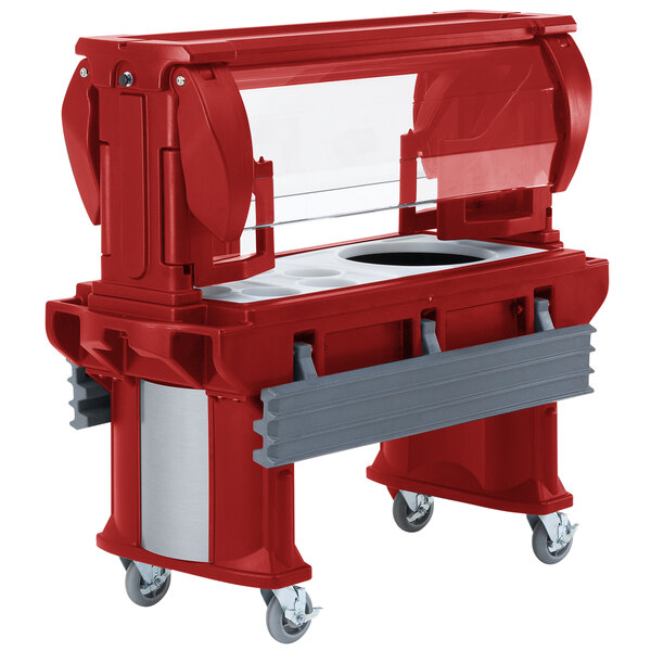 A red food buffet cart with a clear lid.